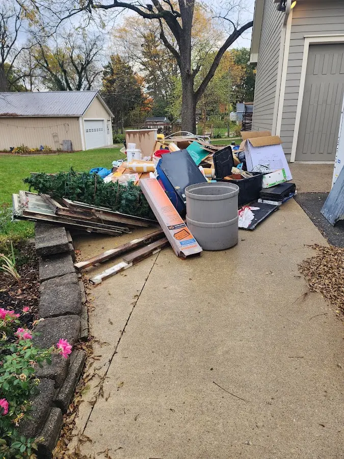 Dumpster being loaded with debris for Estate Cleanout Dumpster Rental in Sellersville